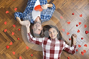 Top view of romantic couple lying on floor, expressing love to soul mate