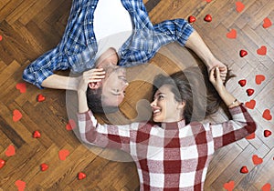 Top view of romantic couple lying on floor, expressing love to soul mate