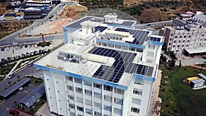 Top view of roof of white building with solar panels. Clip. Modern equipping of buildings with eco-friendly electricity