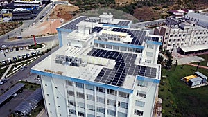 Top view of roof of white building with solar panels. Clip. Modern equipping of buildings with eco-friendly electricity