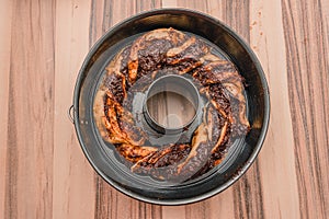 Top view of the round chocolate cake in a round baking pan