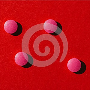 top view of round pink pills with shadows