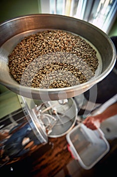 top view of rounded metal dish with whole grin coffee in it