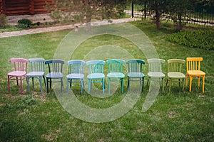 top view of a row of colorful Viennese chairs in a row, a children's birthday party in the garden on the lawn in the