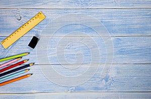 Top view Ruler, pencil and eraser on blue wooden table