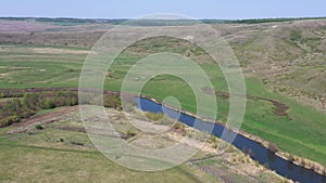 Top view of rural landscape with river and green grazing field