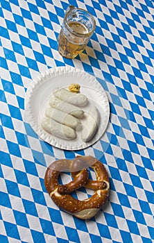 Top view of Sailed pretzel, white sausages and beer on table to