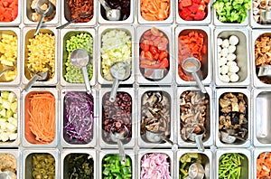Top view of salad bar with assortment of ingredients