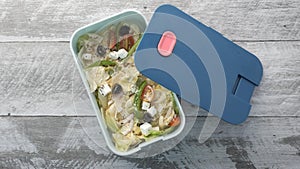 top view of a salad in a lunch box on table