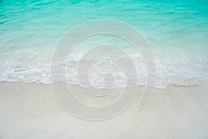 Top view of sand and water clean beach and white sand in summer with sun light blue sky and bokeh background