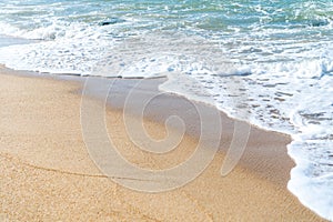 Top view of sand and water clean beach and white sand in summer with sun light blue sky and bokeh background