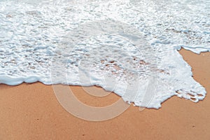 Top view of sand and water clean beach and white sand in summer with sun light blue sky and bokeh background