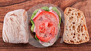 Top view of sandwich on Ciabatta bread on wooden table