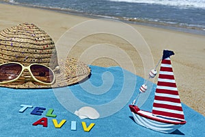 Top view of sandy beach with summer accessories with TEL AVIV word.