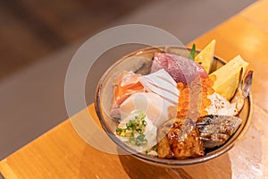 Top view of Sashimi Don, Donburi or Japanese rice bowl with various raw fresh slice of fish, shrimp, squid and tamago egg