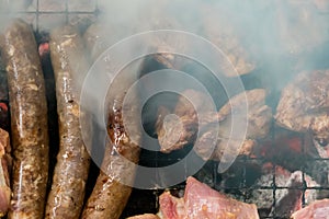 Top view of sausage and meat grilling on barbecue