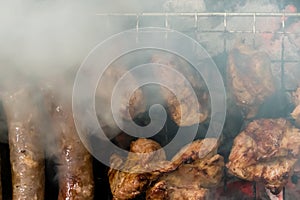 Top view of sausage and meat grilling on barbecue