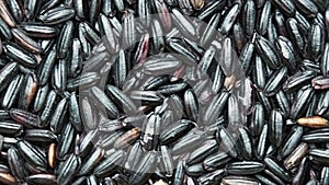 Top view of scattered shelled black glutinous rice on the table. abstract food background