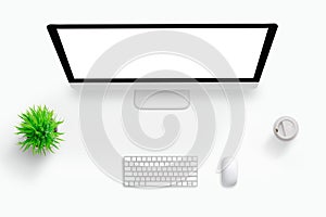 Top view scene of work desk. Computer display with isolated screen for mockup. Plant, keyboard, mouse and coffee beside