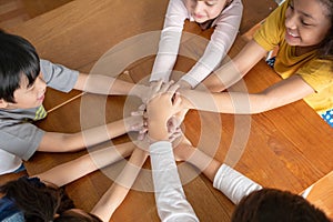 Top view of School pupils putting their hands