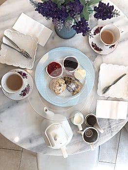 Top view of scones with milk and hot tea,tea break time with dessert on marble table