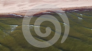 Top view of the sea coastline with green water in summer