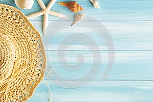 Top view of sea straw hat and sea shells on blue wooden background, Summer concept on empty blue wood floor and copy space