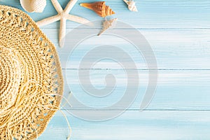 Top view of sea straw hat and sea shells on a blue wooden background, Summer concept on empty blue wood floor and copy space