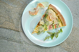 Top view of seafood pizza Slice with prawns, fresh arugula leaves and sliced Parmesan cheese. ingredients ner the dish