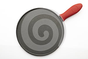 Top View of Seasoned Cast Iron Pan on White Background with Red Silicon Handle Grip