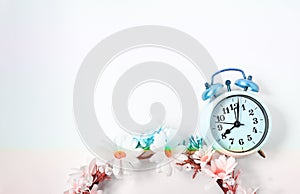 Top view selective focus vintage alarm clock  with beautiful bouquet flowers  on white background. Love anniversary, dating and