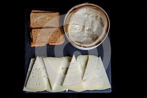 Top view of a semi-cured cheese and spreadable cheese with toast