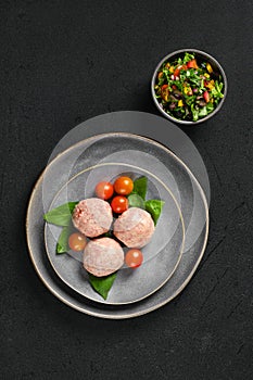 Top view of semifinished frozen veal meatballs on a plate