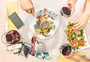 Top view of senior couple hands eating food and drinking wine