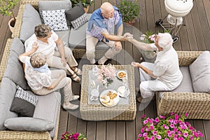 Top view on senior people talking during meeting on the terrace