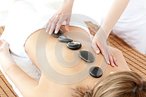 Top view of a serene woman having a stone therapy