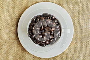 Top view of a served cup filled with coffee beans
