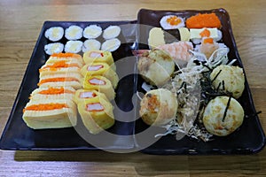 Top view Set Japanese food Sushi on rice Eggs Shrimp Takoyaki Eggs Delicious freshness on a plate on a wooden table