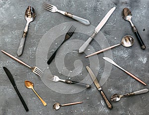 Top view of set silverware on vintage stone background