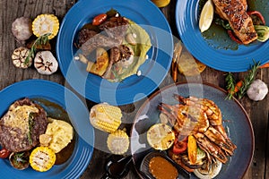 Top view set of smoked grilled bbq meals; meat; fish and vegetables