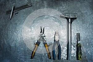 Top view of set working tools lying on metal table