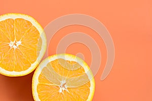 Top view of a several orange fruit slices on bright background i