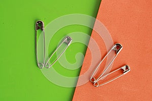 Top view of sewing pins on colorful background