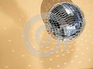 Top view shiny disco ball with sparkles reflections on a surface