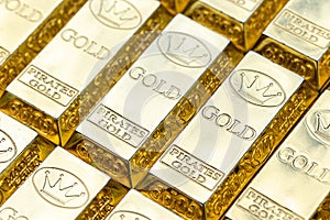 Top view of shiny gold bars stacked up in rows. Gold Bars 1000 grams. Concept of success in business and finance