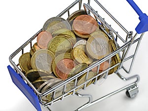 Top view of shopping cart with euro coins isolated on white background, close up