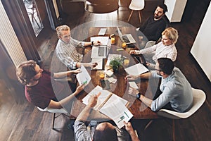 Top view shot of business people in modern office. Men and women