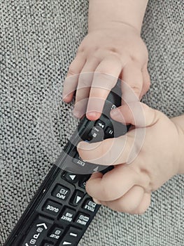 Top view shot of a cute little kid playing with remote control