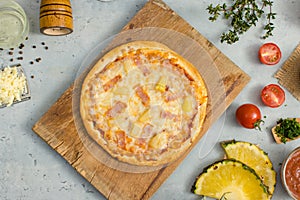 Top view shot of delicious tasty juicy of Hawaiian traditional Italian crust thin crispy ham and pineapple pizza placed on wooden