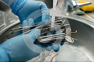 Top view shot of dentist cleaning the dental instruments